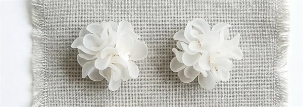 dolman bijoux narciso orecchini bianchi fiore lobo 2026